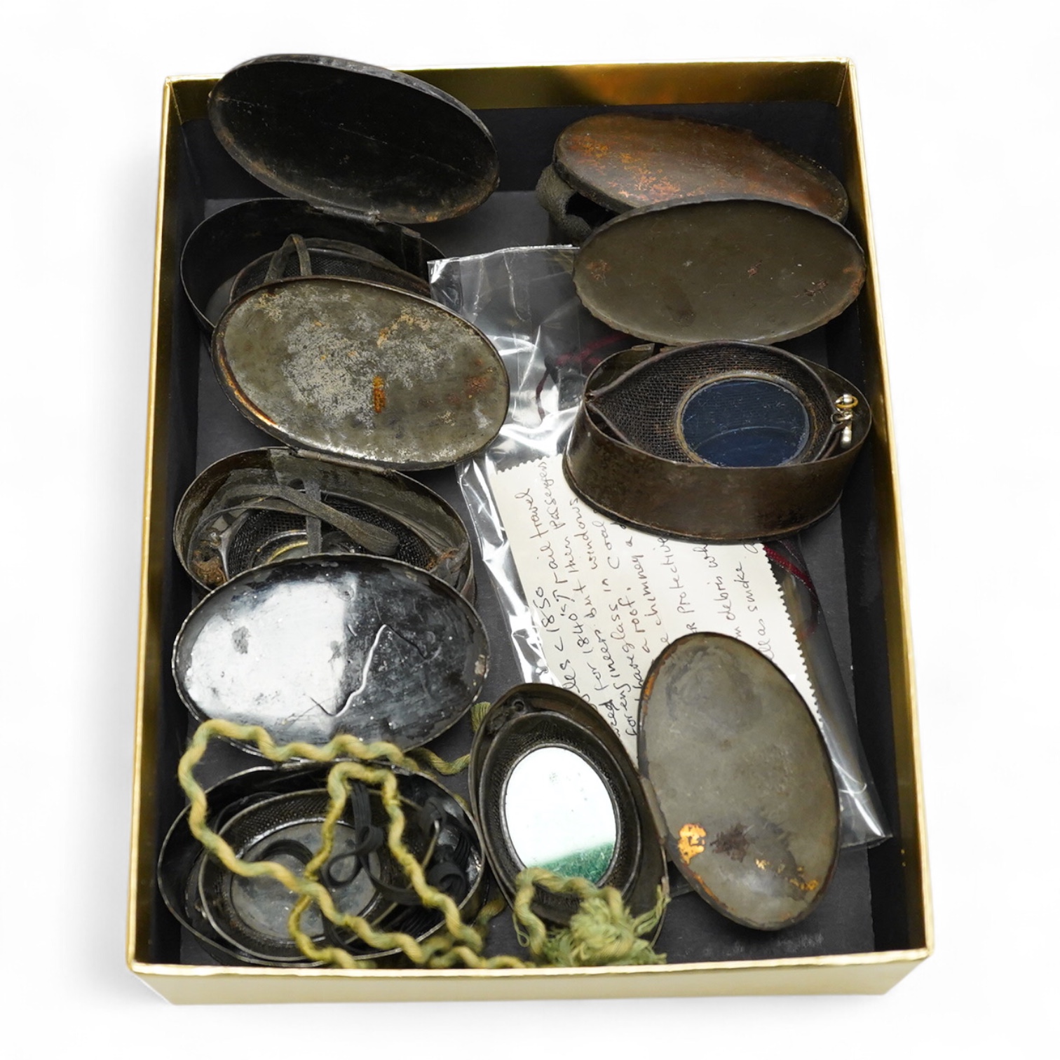 Five pairs of early 20th century goggles with mesh side protectors, two pairs colour tinted, in original tin boxes and two pairs of mesh eye protectors (7)